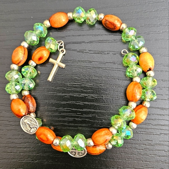 Green and brown coil bracelet with cross charm - Picture 1 of 6